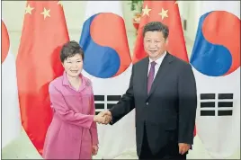 ?? LINTAO ZHANG/POOL/REUTERS ?? Chinese President Xi Jinping, right, shakes hands with South Korean President Park Geun-hye on Wednesday at The Great Hall Of The People in Beijing, China.