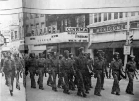  ?? Courtesy of Mark E. Jackson and Jr. Herd archives ?? Members of Jr. Herd Drill Team march on Seventh Avenue in Beaver Falls circa 1971.