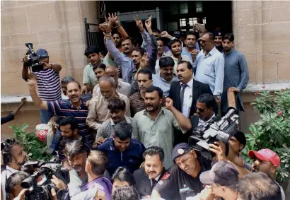  ?? — AP ?? Detained supporters of the Muttahida Qaumi Movement raise slogans after their court appearance in Karachi on Wednesday. Some 44 MQM leaders and supporters appeared in court where a judge ordered them sent to prison pending trial.