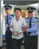 ?? PROVIDED TO CHINA DAILY ?? Song Miqiu, a fraud suspect who fled China, is escorted from an aircraft upon his return.