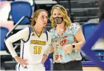  ?? STAFF FILE PHOTO BY ROBIN RUDD ?? UTC women’s basketball coach Katie Burrows, right, and her Mocs closed the regular season with a 65-54 win Thursday night at East Tennessee State. Dena Jarrells, left, came off the bench to score a game-high 17 points.