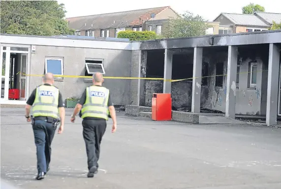  ?? Picture: David Wardle. ?? Police assessing the damage at the Fife school.