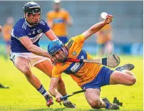  ??  ?? CLOSE CONTEST: Shane O’Donnell tries to get past Donnchadh Hartnett of Laois at Nowlan Park