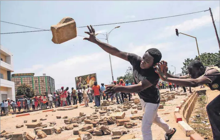  ??  ?? Youthful discontent: Protesters hurl bricks at Togolese security forces during a demonstrat­ion against President Faure Gnassingbé in Lomé.