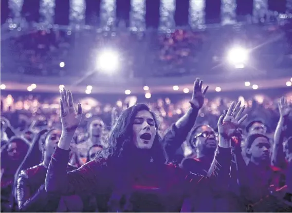  ?? Elizabeth Conley / Staff photograph­er ?? The crowd reacts to rapper Kayne West’s performanc­e with a choir of songs from his “Jesus Is King” album during his Sunday Service Experience at Lakewood Church.