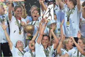  ?? STREETER LECKA/GETTY IMAGES ?? Abby Erceg celebrates with the NWSL championsh­ip trophy after the North Carolina Courage defeated the Chicago Red Stars 4-0.