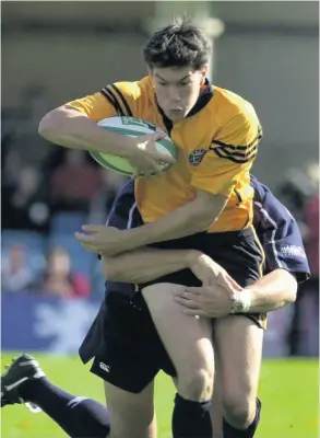  ?? PICTURE: Dave ROGERS/ALLSPORT ?? Bath’s Tom Voyce is tackled by Swansea’s defence during their 2001 Heineken Cup match