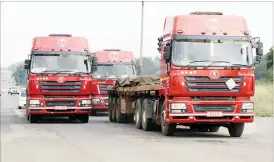  ??  ?? Haulage trucks are a major contributo­r to the damage on the country’s road network, negating Government and councils’ efforts to repair the roads. The picture taken recently shows trucks passing through Bulawayo along Gwanda Road. (Picture by Eliah Saushoma)