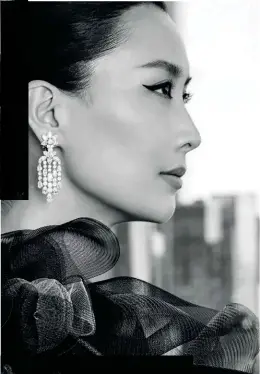  ?? ?? Coat, Giorgio Armani.
Diamond cluster chandelier earrings, Harry Winston.