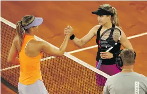  ?? JULIAN FINNEY / GETTY IMAGES ?? After beating Maria Sharapova Monday, the 5-foot-10 Eugenie Bouchard shook the 6-foot-2 Sharapova’s hand at the net and then stared straight into her eyes.