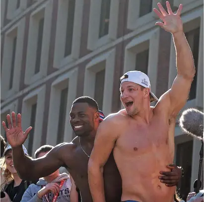  ?? MATT STONE / HERALD STAFF FILE ?? CERVEZA, PLEASE: Patriots tight end Rob Gronkowski, right, celebrates a Super Bowl victory over the Rams with teammate Dwayne Allen during a parade through the city on Feb. 5, 2019.