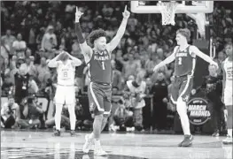  ?? Ryan Sun Associated Press ?? ALABAMA’S Mark Sears (1) and Grant Nelson begin the celebratio­n after the Crimson Tide ousted No. 1 North Carolina in a Sweet 16 game on Thursday night.