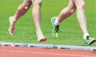  ?? PHOTOS: STEPHEN JAQUIERY ?? Barefooted . . . The bare feet of Danny Baillie chase the spikes of Aaron Anderson in the Otago 5000m championsh­ips at the Caledonian Ground on Saturday.