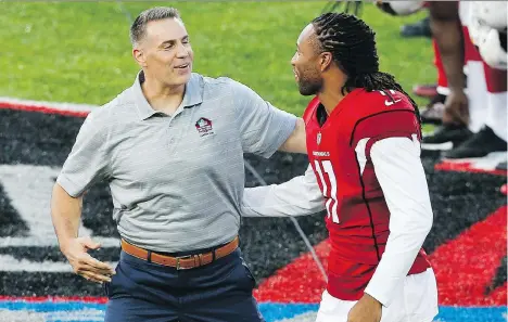  ?? THE ASSOCIATED PRESS ?? Former St. Louis Rams and Arizona Cardinals quarterbac­k Kurt Warner, left, who had a great connection with receiver Larry Fitzgerald during his playing days, is now a member of the Pro Football Hall of Fame.