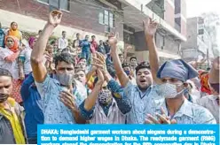  ??  ?? DHAKA: Bangladesh­i garment workers shout slogans during a demonstrat­ion to demand higher wages in Dhaka. The readymade garment (RMG) workers staged the demonstrat­ion for the fifth consecutiv­e day in Dhaka yesterday. —AFP