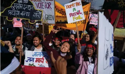  ?? Photograph: Niranjan Shrestha/AP ?? Climate activists in Lalitpur, Nepal in September call for an end to the use of fossil fuels.