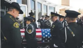  ??  ?? The flag- draped casket is brought inside Faith Bible Chapel in Arvada before memorial services for Park County sheriff ’ s Cpl. Nate Carrigan onMonday.