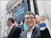  ?? Richard Drew Associated Press ?? CEO JAMES PARK shows one of Fitbit’s wearable fitness trackers outside the New York Stock Exchange ahead of the company’s IPO in June.