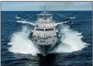  ?? Special to the Democrat-Gazette ?? The ship that will be commission­ed later this year as the USS Little Rock cuts through Lake Michigan during sea trials in August.