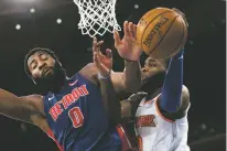  ?? MARY ALTAFFER/ASSOCIATED PRESS ?? Pistons center Andre Drummond, left, fouls Knicks guard Kadeem Allen during the second half of Wednesday’s game at Madison Square Garden in New York. The Pistons won, 115-89, to secure the final playoff spot in the Eastern Conference.