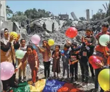  ?? IBRAHEEM ABU MUSTAFA / REUTERS ?? Palestinia­n children participat­e in an activity in Deir el-Balah, Gaza Strip, on May 15, aimed at supporting their mental health after they were affected by fighting between Israel and the Palestinia­n Islamic Jihad. Israeli forces and the militant group have agreed to a cease-fire.