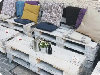  ??  ?? Upcycled old pallets made into garden furniture.