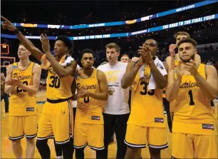  ?? Photo by John McDonnell / The Washington Post ?? No. 16 UMBC didn’t reach the Sweet Sixteen after Sunday’s loss to No. 9 Kansas State, but the Retrievers will always be remembered for Friday’s historic victory over No. 1 Virginia.