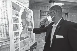  ?? ROGELIO V. SOLIS/ASSOCIATED PRESS FILE PHOTO ?? Sen. Sollie Norwood, a Democrat, points out his district last month on a poster-sized map in the Capitol rotunda in Jackson, Miss. Redistrict­ing is the once-a-decade process by which state legislatur­es redraw political maps. Parties can gain major advantages if they draw seats in a way that favors their candidates.