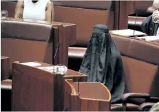  ?? JED COOPER/THE ASSOCIATED PRESS ?? Sen. Pauline Hanson wears a burqa during question time in the Senate chamber at Parliament House in Canberra, Australia, on Thursday.