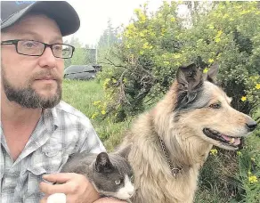  ??  ?? Michael Bednar, 47, a photograph­er who moved to 108 Mile Ranch from Vancouver six years ago, took the time to gather up his neighbour’s cat and dog after fleeing from his home. — MICHAEL