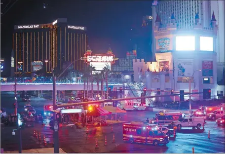  ?? © STEVE MARCUS/LAS VEGAS SUN VIA ZUMA WIRE ?? Las Vegas Metro Police and medical workers stage in the intersecti­on of Tropicana Avenue and Las Vegas Boulevard South after the shooting.