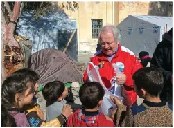  ??  ?? To hell and back: Brian with some of the refugee children he and Valerie helped in Greece