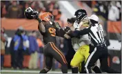  ?? RON SCHWANE — THE ASSOCIATED PRESS ?? Myles Garrett swings the helmet of Steelers quarterbac­k Mason Rudolph late in the game Nov. 14at FirstEnerg­y Stadium.