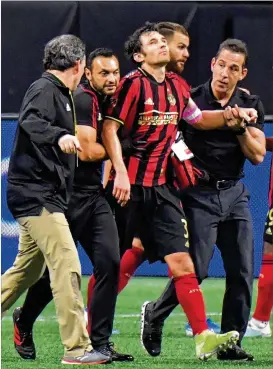  ?? HYOSUB SHIN / HYOSUB.SHIN@AJC.COM ?? Michael Parkhurst is helped off the field after he was injured in the second half during the first round of the MLS playoffs at Mercedes-Benz Stadium on Saturday. Atlanta United won 1-0 over the New England Revolution.