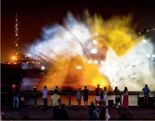  ?? Game of Thrones Photos by Neeraj Murali and Juidin Bernarrd ?? Visitors watch the show on the world’s largest water projection screen as part of the Imagine show at the Dubai Festival City . The scenes are projected on water screens formed from the spray of 30 fountains created specially for the event and are...