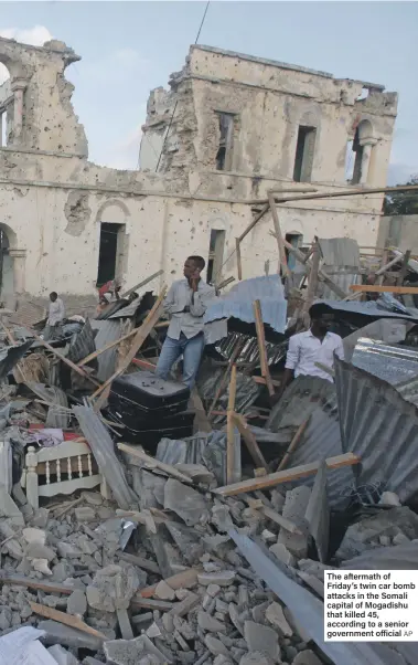  ?? AP ?? The aftermath of Friday’s twin car bomb attacks in the Somali capital of Mogadishu that killed 45, according to a senior government official