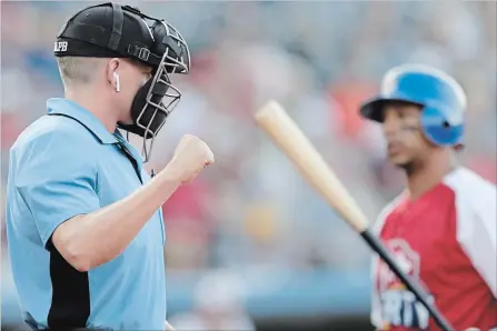  ?? JULIO CORTEZ THE ASSOCIATED PRESS ?? Home plate umpire Brian deBrauwere, left, calls a strike given to him by a radar system over an earpiece.