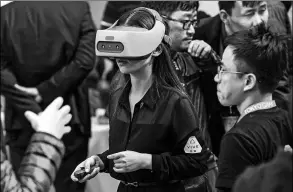  ?? PROVIDED TO CHINA DAILY ?? A visitor checks out a Vive Focus at a developer conference held in Beijing. Users can enjoy the device without attaching it to personal computers or smart phones.