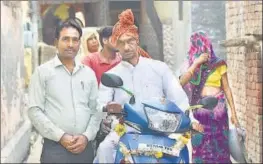 ?? YOGENDRA KUMAR/HT PHOTO ?? Kude Ram, 60, (sitting on a scooter) had dreamt of travelling in a helicopter. Ram spent ₹3.25 lakh on hiring a helicopter and documentat­ion to travel to his village Sadpura from a government school in Neemka, Faridabad, after his retirement.