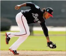  ?? CURTIS COMPTON / CCOMPTON@AJC.COM ?? Second baseman Ozzie Albies handles a hot grounder during a Braves’ workout in Lake Buena Vista, Fla. The Braves have high hopes for the 21-year-old.