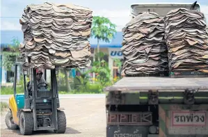  ?? PATIPAT JANTHONG ?? A man drives a forklift to unload rubber sheet at a market in Surat Thani province. Rubber producer Sri Trang is increasing production capacity to take advantage of rising demand.