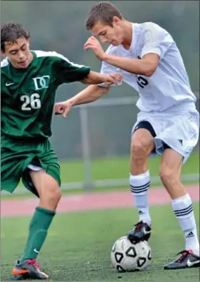  ?? For Montgomery Media / MARK C. PSORAS ?? Christophe­r Dock’s Logan Hunsberger works a ball around a Delco Christian defender during Tuesday’s Bicentenni­al League action.