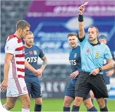  ??  ?? Sam Stubbs is shown the red card