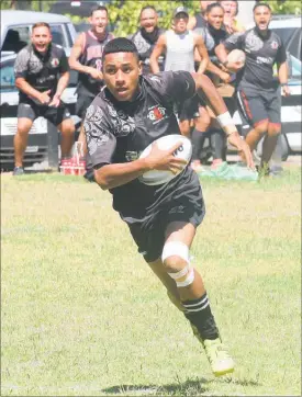  ??  ?? Panguru’s Eroni Biukoto finds room to move - much to the delight of his teammates on the sideline - in the pre-season friendly against Kaikohe at Panguru on Saturday.