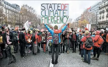  ?? ETIENNE LAURENT/EPA ?? Protesters voice their position during a December 2015 march in Paris. The U.S. may withdraw from the climate pact.