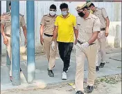  ?? HT PHOTO ?? ■
Suspended Kharkhauda station house officer Jasbir Singh (yellow T-shirt) in police custody in Rohtak on Wednesday.