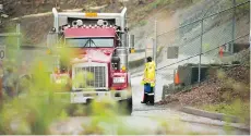  ?? ARLEN REDEKOP ?? A truck leaves Kinder Morgan property on Tuesday, two days after the company said it’s scaling back work on the pipeline.