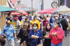  ?? RICH PEDRONCELL­I/ASSOCIATED PRESS ?? People walk along Fisherman’s Wharf in Monterey, California, in early August. California voters have until Tuesday to cast their ballots to either keep Gov. Gavin Newsom or recall and replace him.