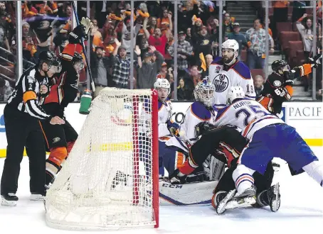  ?? HARRY HOW/GETTY IMAGES ?? Anaheim Ducks centre Ryan Kesler connects with Edmonton Oilers goaltender Cam Talbot in the crease during the waning seconds of the third period in Game 5 on Friday in Anaheim, Calif. The Oilers claimed goaltender interferen­ce, but the goal stood — and...