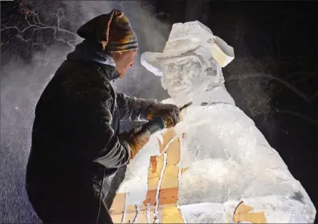  ?? WAYNE EMDE/Special to The Daily Courier ?? Carver Ryan Cook and his team work Sunday night, when it was colder, to complete the series of carvings for the Vernon Winter Carnival. The sculptures have been draped and dry ice is used to keep them cold during the day. The carnival runs Feb. 5-14. See vernonwint­ercarnival.com for details.